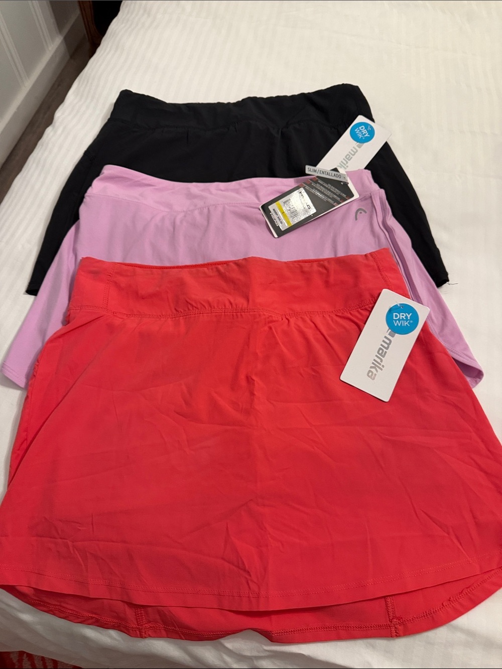 Marika and head Active Skort Trio in Coral, Lavender, and Black